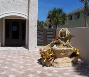 Stotz fountain, six feet tall, note the coquina stucco on the house