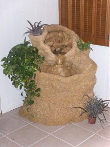 Custom corner shaped 36" scale fountain sitting on a custom base